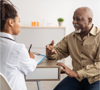 Older African American man speaking to his care provider