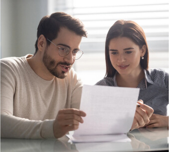 Couple at a desk reviewing paperwork together