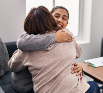 Caregiver hugging patient